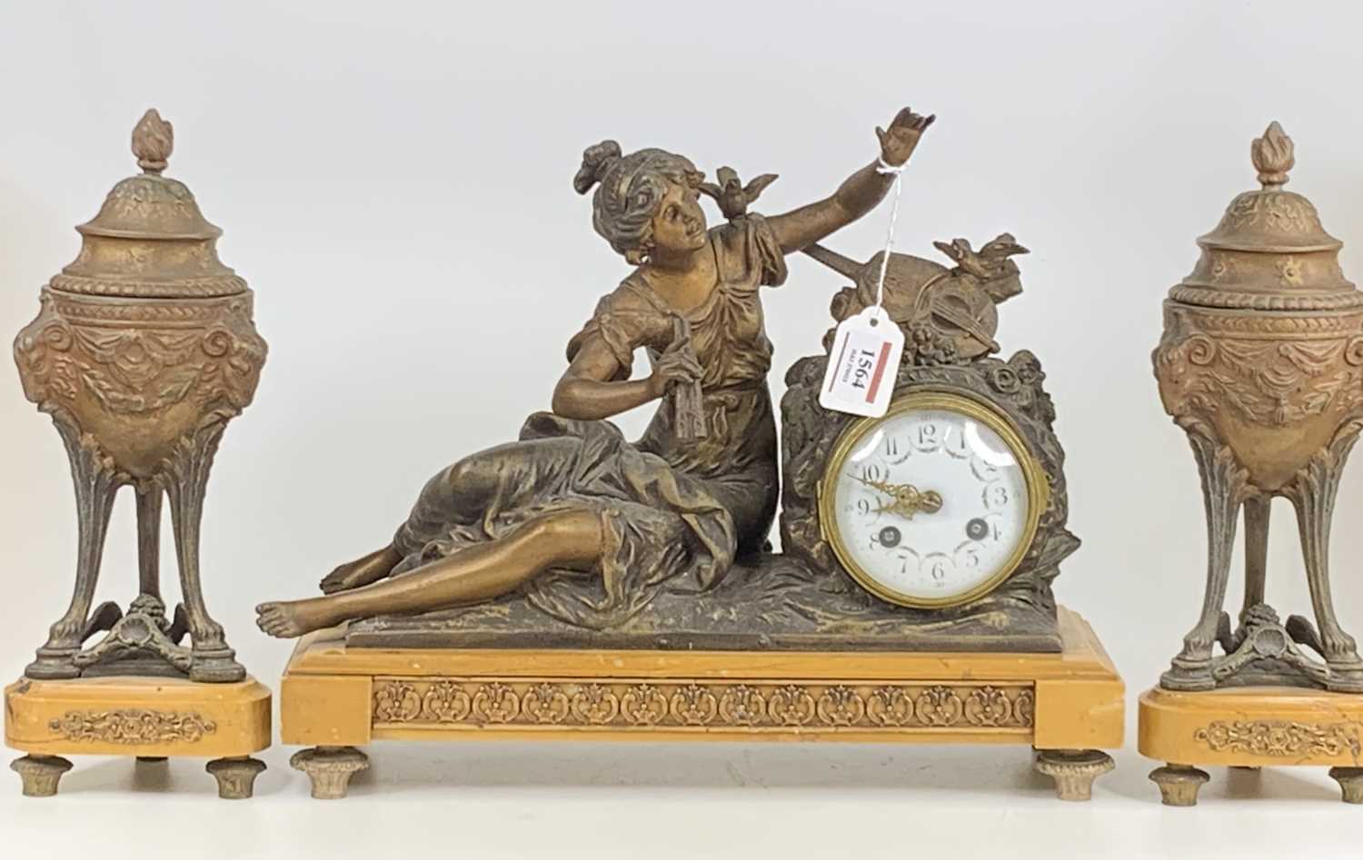 An early 20th century bronzed spelter and marble three-piece clock garniture, the clock as a