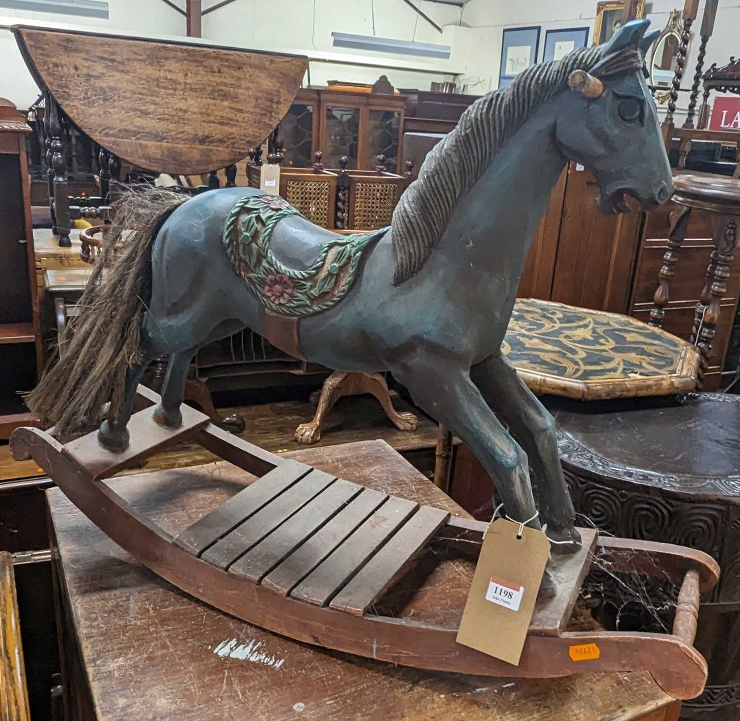 A child's hardwood and polychrome painted rocking horse, length of base 83cm