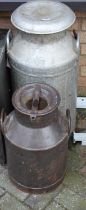A galvanised twin handled milk churn and cover, together with one other similar (2) In used