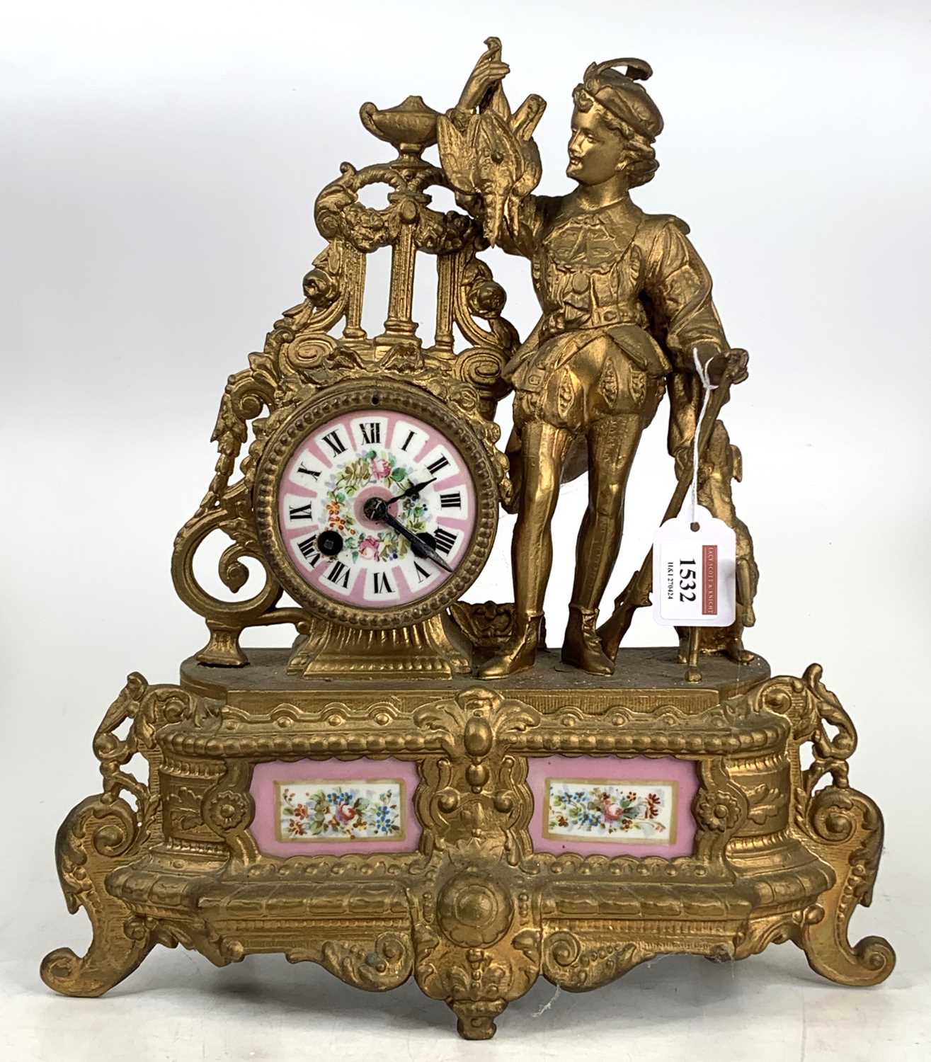 A late 19th-century French gilt metal and porcelain inset mantel clock having a huntsman flanking