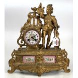 A late 19th-century French gilt metal and porcelain inset mantel clock having a huntsman flanking