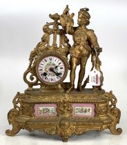A late 19th-century French gilt metal and porcelain inset mantel clock having a huntsman flanking