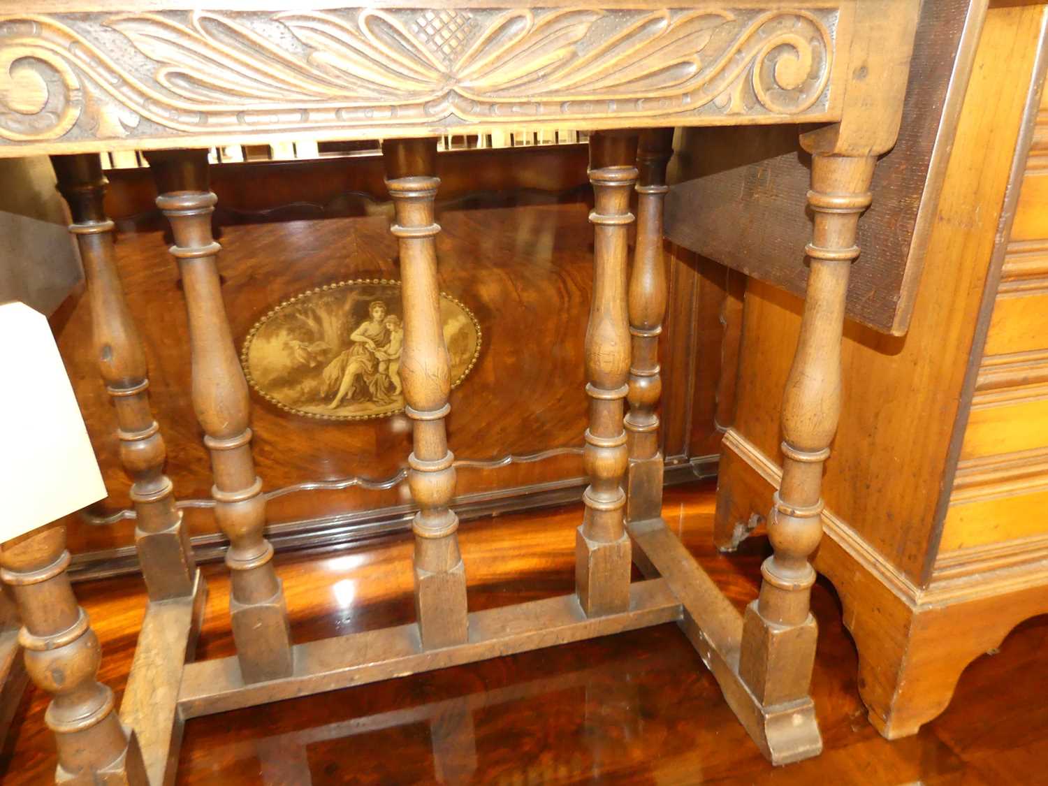 A joined oak dropflap low occasional table, having a carved frieze, raised on turned and square - Image 2 of 2