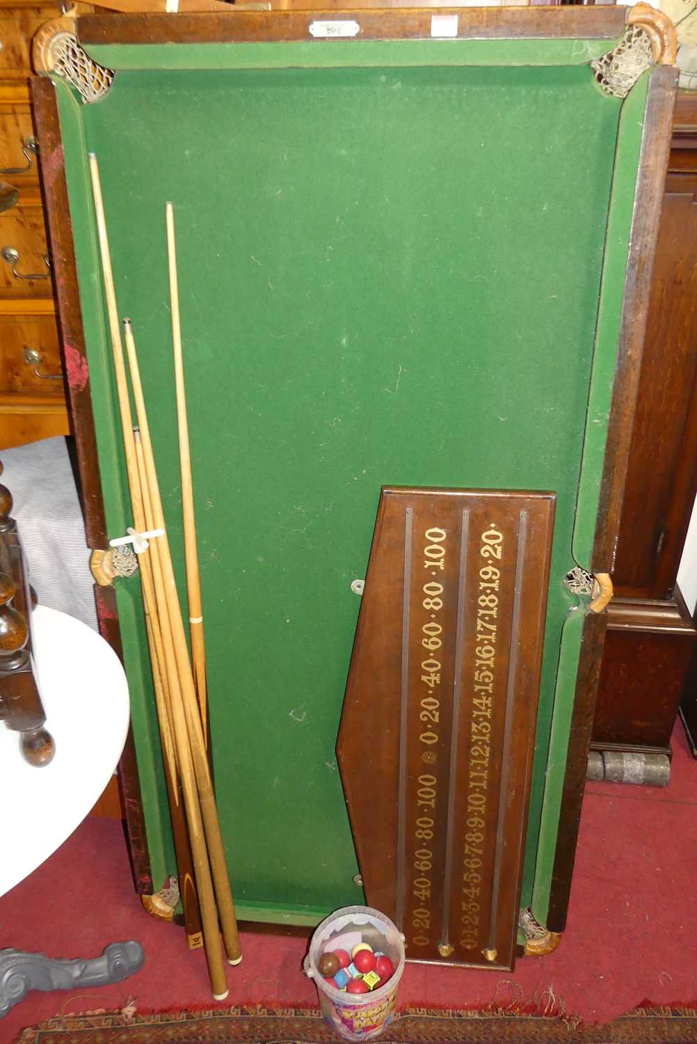 A Sykes of London quarter size snooker table, with oak wall mounted scoreboard, sundry cues, and