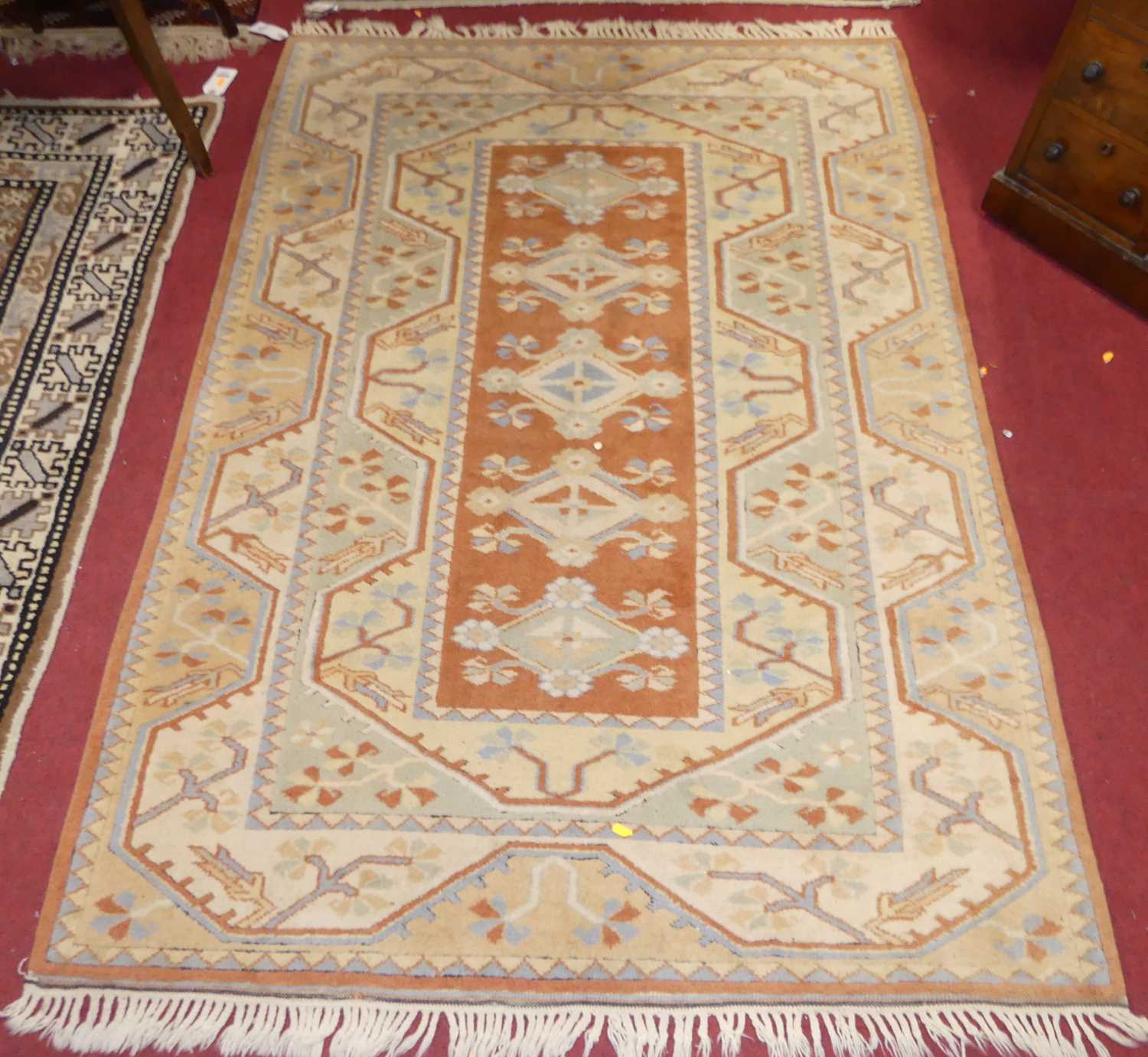 A Turkish woollen cream and orange ground Oushak rug, 180 x 129cm