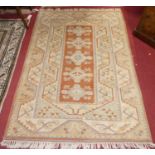 A Turkish woollen cream and orange ground Oushak rug, 180 x 129cm