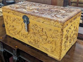 A Chinese heavily carved camphorwood hinge top blanket chest, decorated with wild & wading birds