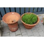 A terracotta circular garden planter, together with one other similar on base (2)