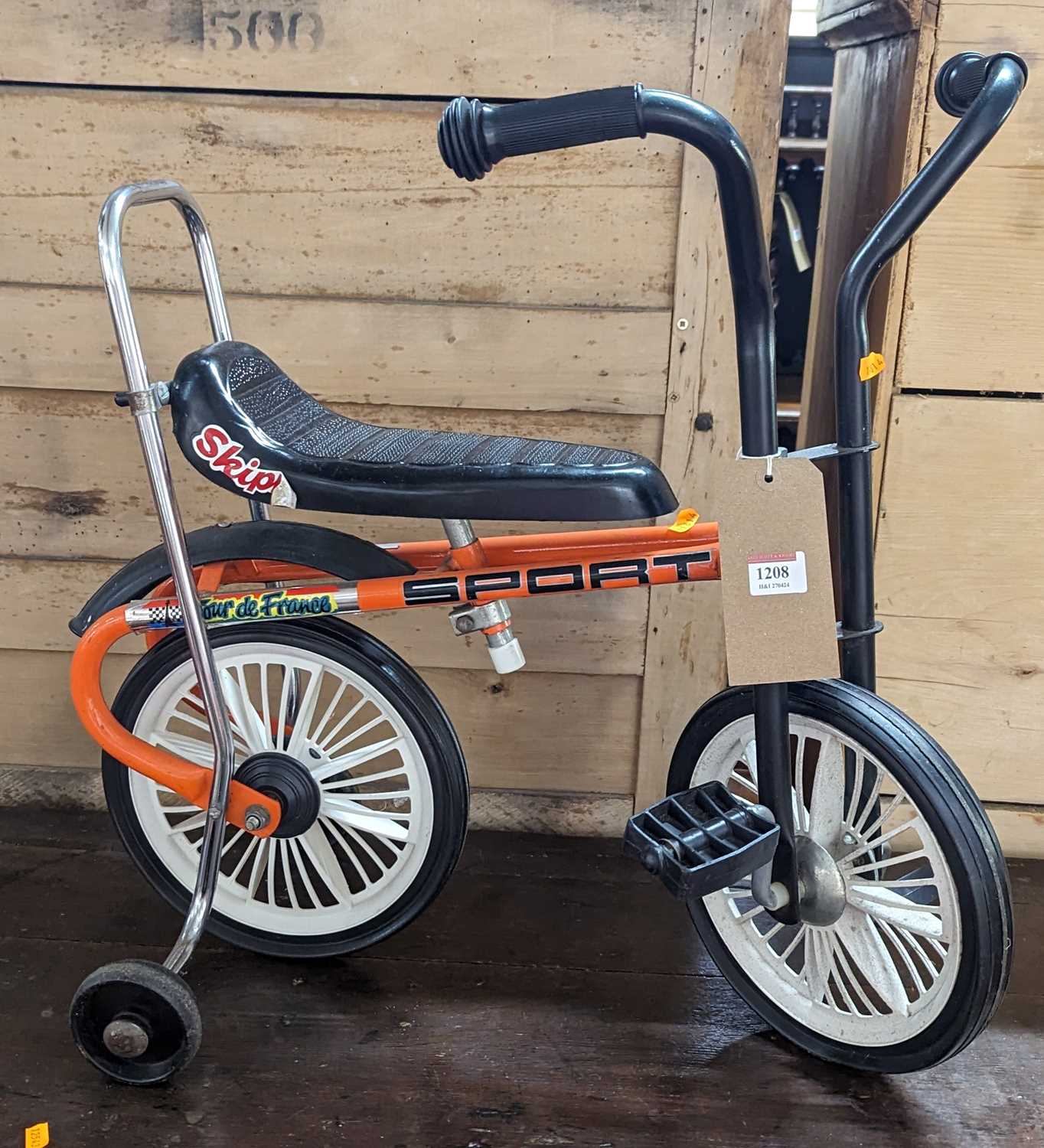 A 1970s children's vintage tricycle, with rear stabliser wheels