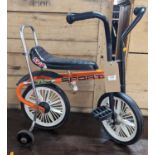 A 1970s children's vintage tricycle, with rear stabliser wheels