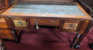 A late Victorian Aesthetic Movement walnut and gilt tooled leather inset kneehole writing table,