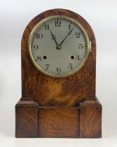 A late 19th century figured walnut dome top mantel clock, having an unsigned silver dial, and spring