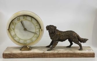 An Art Deco marble mantel clock surmounted with a bronzed spelter dog, width 50cm