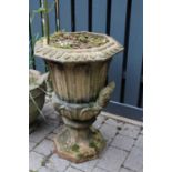 A terracotta twin handled pedestal garden urn, having octagonal top with repeating leaf design,