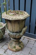 A terracotta twin handled pedestal garden urn, having octagonal top with repeating leaf design,