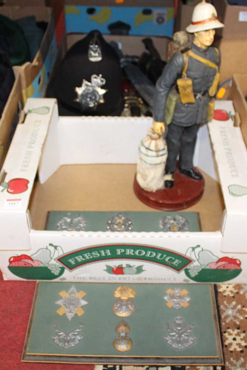 Two boxes of miscellaneous items to include a cast resin figure of a soldier, hand-written verso '