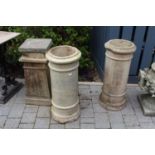 A pair of cream painted terracotta cylindrical chimney tops, each height 76cm, together with a