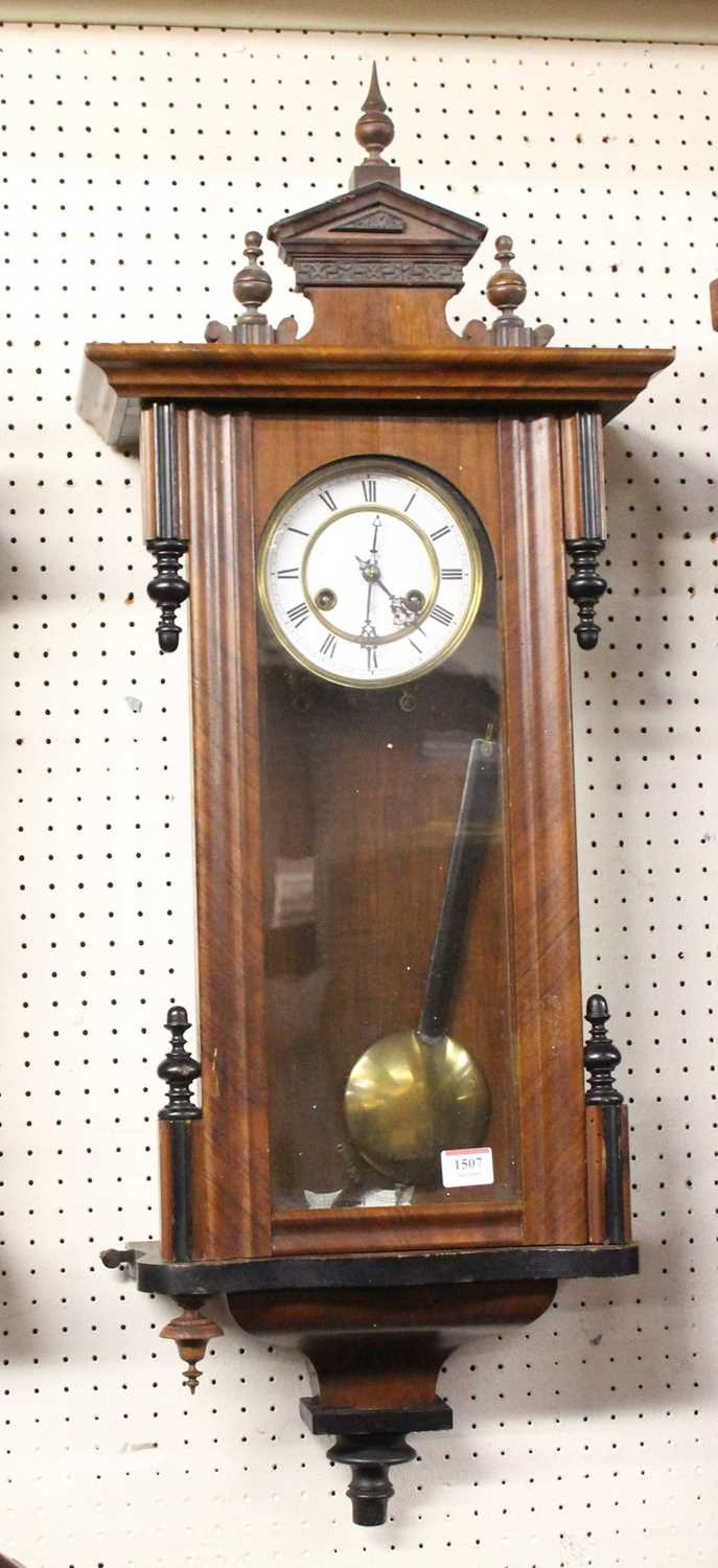 A late 19th century Vienna walnut cased and ebonised droptrunk wall clock, h.90cm
