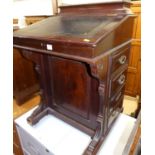 A late Victorian mahogany slopefront davenport, having a leather gilt-tooled inset surface, hinged