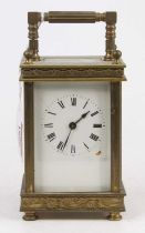A late 19th century French lacquer brass carriage clock, the case with chased decoration, height
