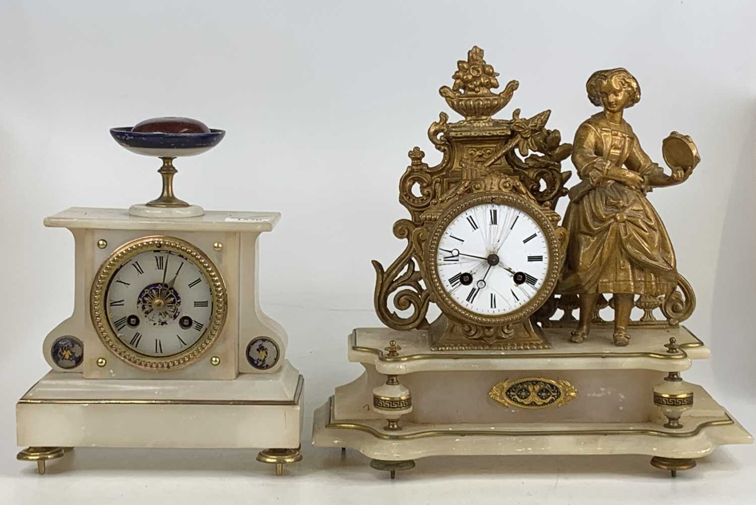 A circa 1900 alabaster and gilt metal mantel clock (re-gilded), the white enamel dial flanked by a
