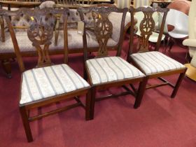 A set of three Chippendale style mahogany splatback dining chairs, each having striped upholstered