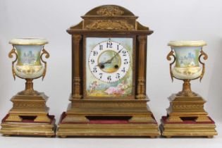 A circa 1900 gilt brass and porcelain three-piece clock garniture, the clock having French brass