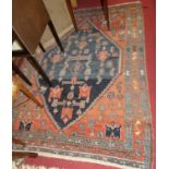 A Persian woollen red and blue ground Shiraz rug, 195 x 140cm