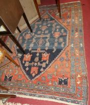 A Persian woollen red and blue ground Shiraz rug, 195 x 140cm