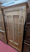 A rustic pine single door side cupboard having interior shelves over single long lower drawer, width