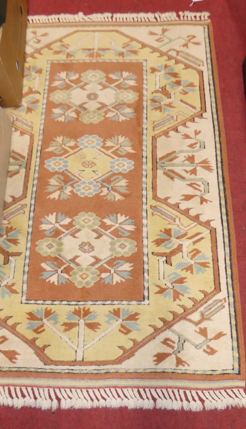 A Persian woollen mustard ground Tabriz rug, 210 x 124cm, together with a Turkish woollen cream - Image 2 of 2