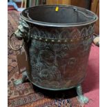 A 19th century Dutch embossed brass circular coal bucket, having twin lion mask handles