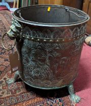 A 19th century Dutch embossed brass circular coal bucket, having twin lion mask handles