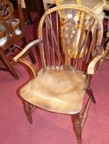 A 19th century elm, beech and fruitwood wheelback single elbow chair, on turned supports, w.52cm