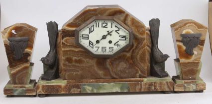 An Art Deco marble and onyx three-piece clock garniture, the clock surmounted with twin birds,