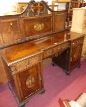 An early 20th century mahogany inverted breakfront ledgeback sideboard, having gadrooned edge, three