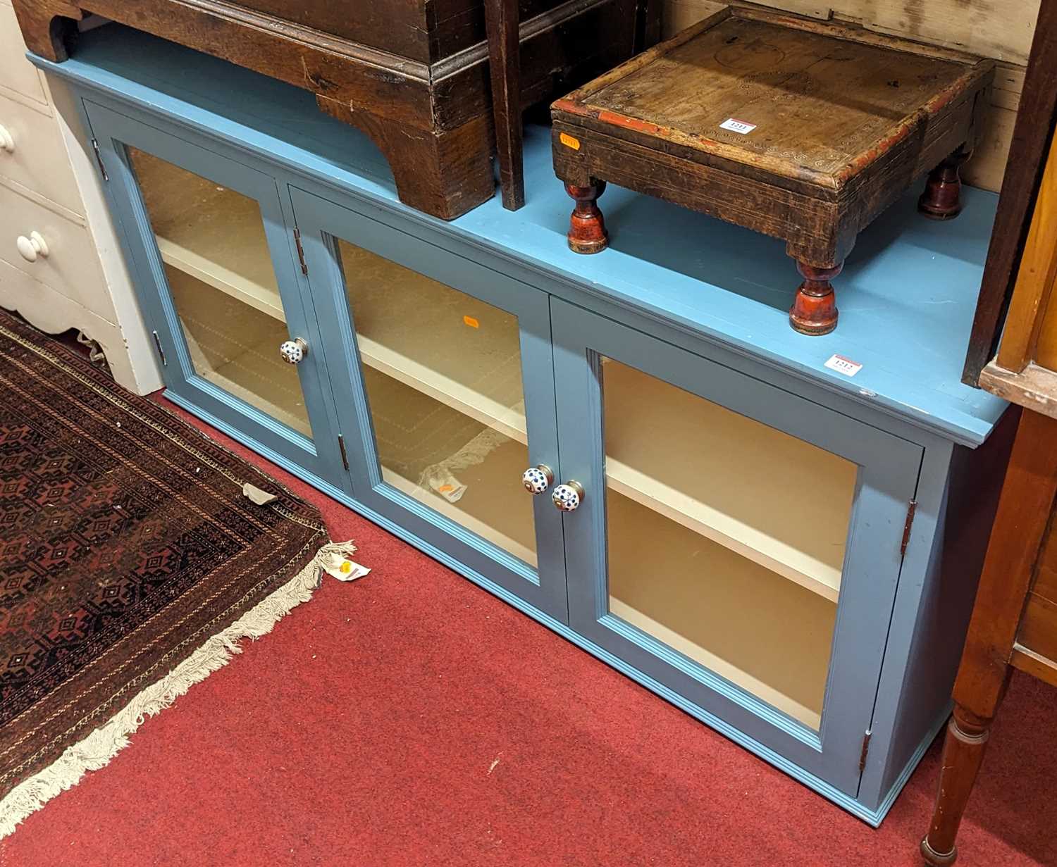 A contemporary blue painted pine three-door glazed hanging wall cabinet, width 160cm
