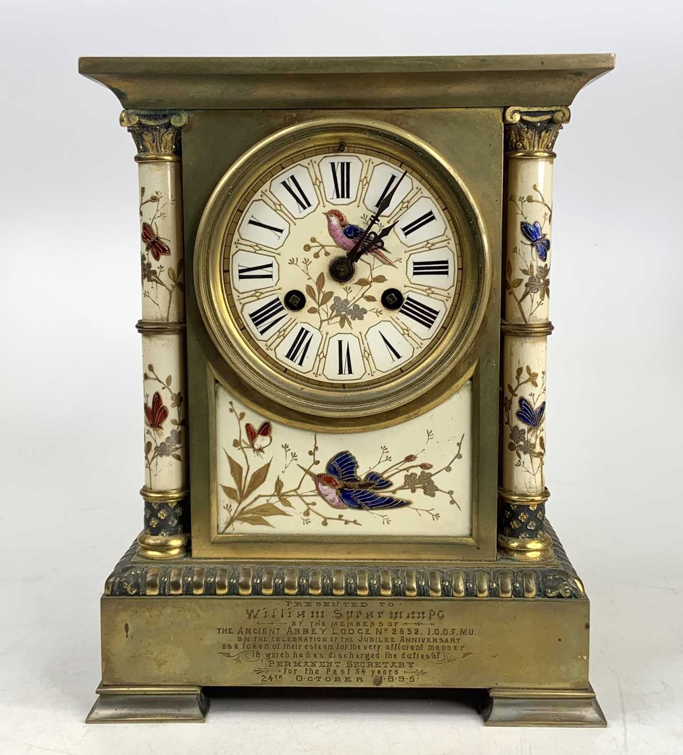 A late 19th century gilt bronze and soft paste porcelain mantel clock (lacking marble top) having