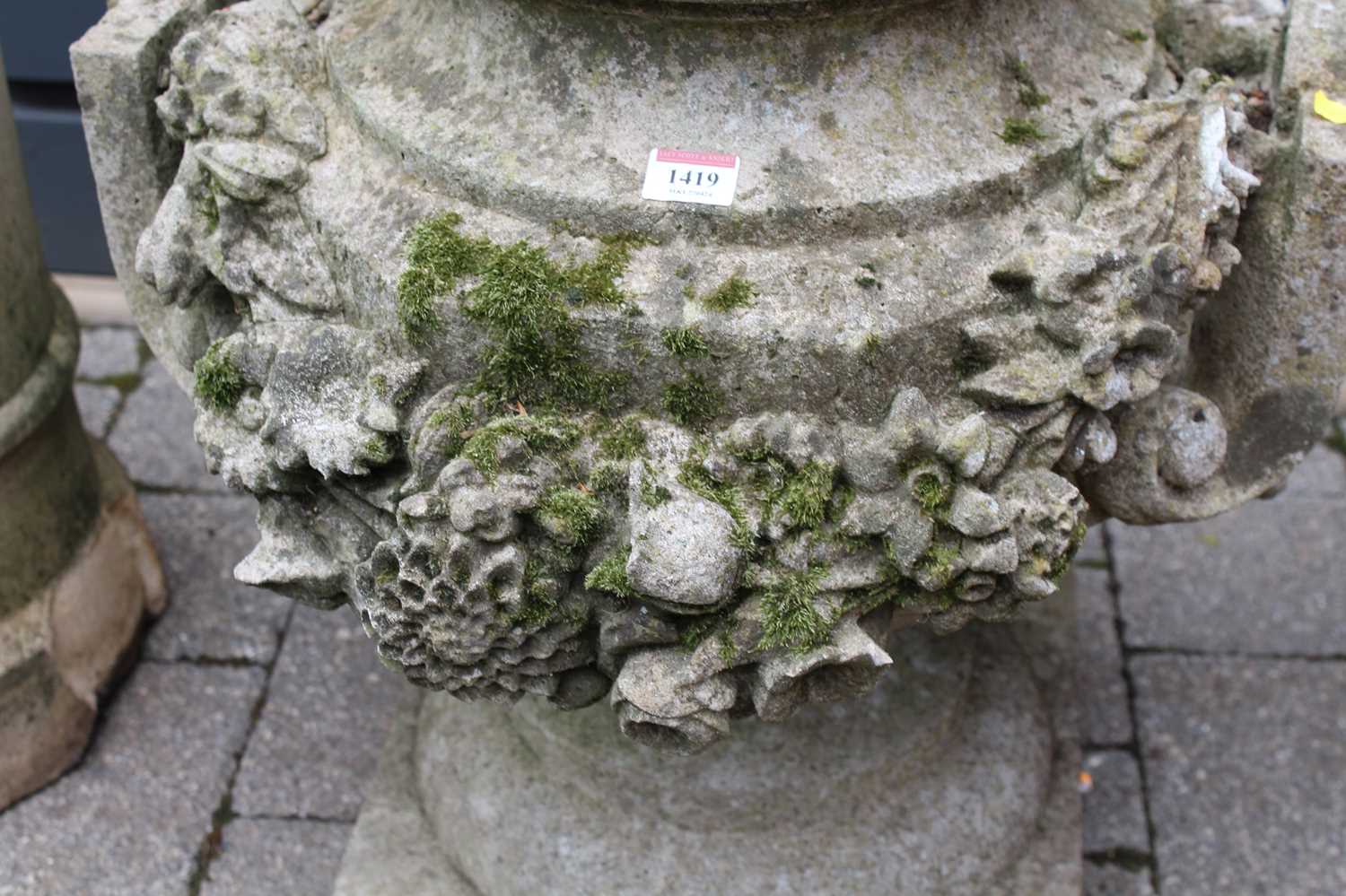 A reconstituted stone twin handled footed garden planter, decorated with heavy floral motifs, height - Image 2 of 3