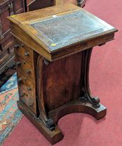 A mid-Victorian rosewood slope front Davenport, the tan leather inset surface enclosing interior