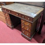 A Victorian faded walnut and leather inset twin pedestal writing desk, having an arrangement of nine