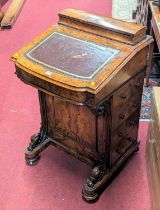 A mid-Victorian figured walnut slope front Davenport, having a gilt tooled tan leather inset