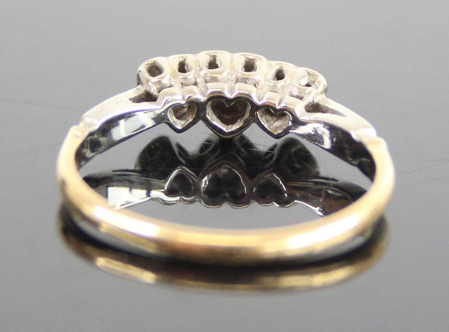 A yellow and white metal diamond three-stone ring, having three single cut diamond in heart shaped - Image 3 of 6