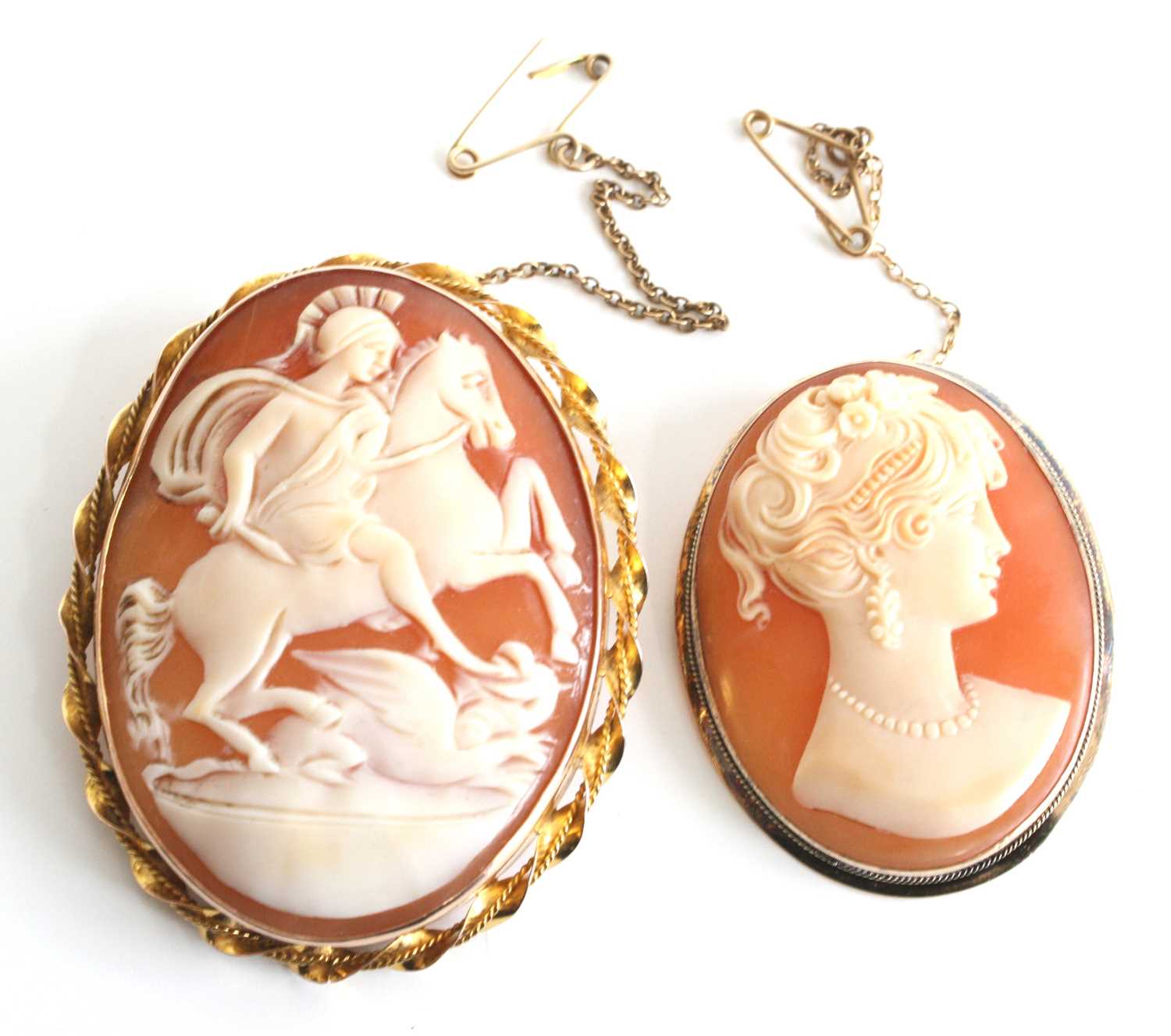 Two oval shell cameo brooches, one being 9ct yellow gold depicting Diana goddess of hunting