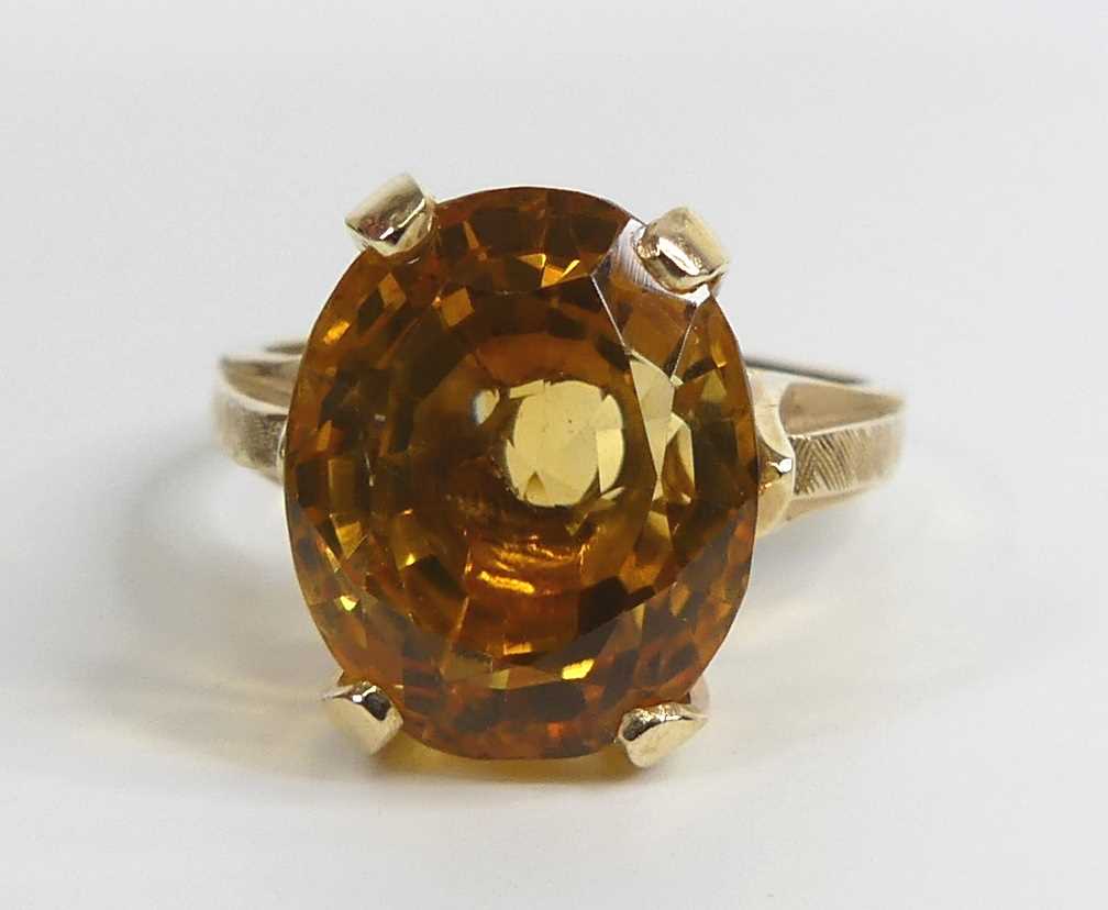 A yellow metal citrine single stone ring, featuring an oval citrine in a four-claw setting with - Image 2 of 7