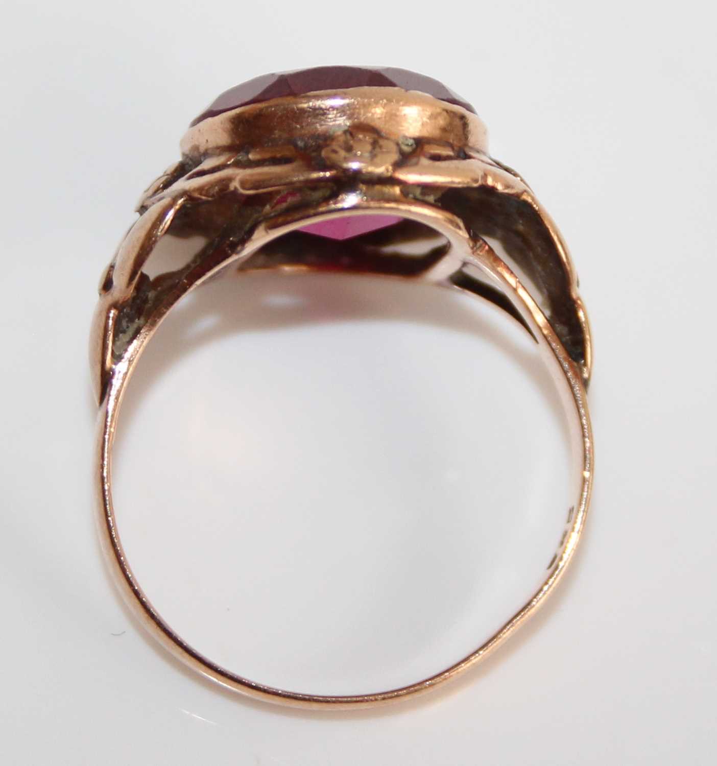 A yellow metal and synthetic ruby set dress ring, the large round cut red stone measuring approx - Image 5 of 6