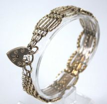 A 9ct gold gatelink bracelet, having heart shaped padlock clasp and safety chain, 20.7g, length 18.
