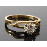 A yellow and white metal contemporary diamond solitaire ring, comprising a round brilliant cut