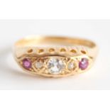 An 18ct yellow gold ruby half hoop eternity ring featuring 2 round rubies, 2 rose cut diamonds and a