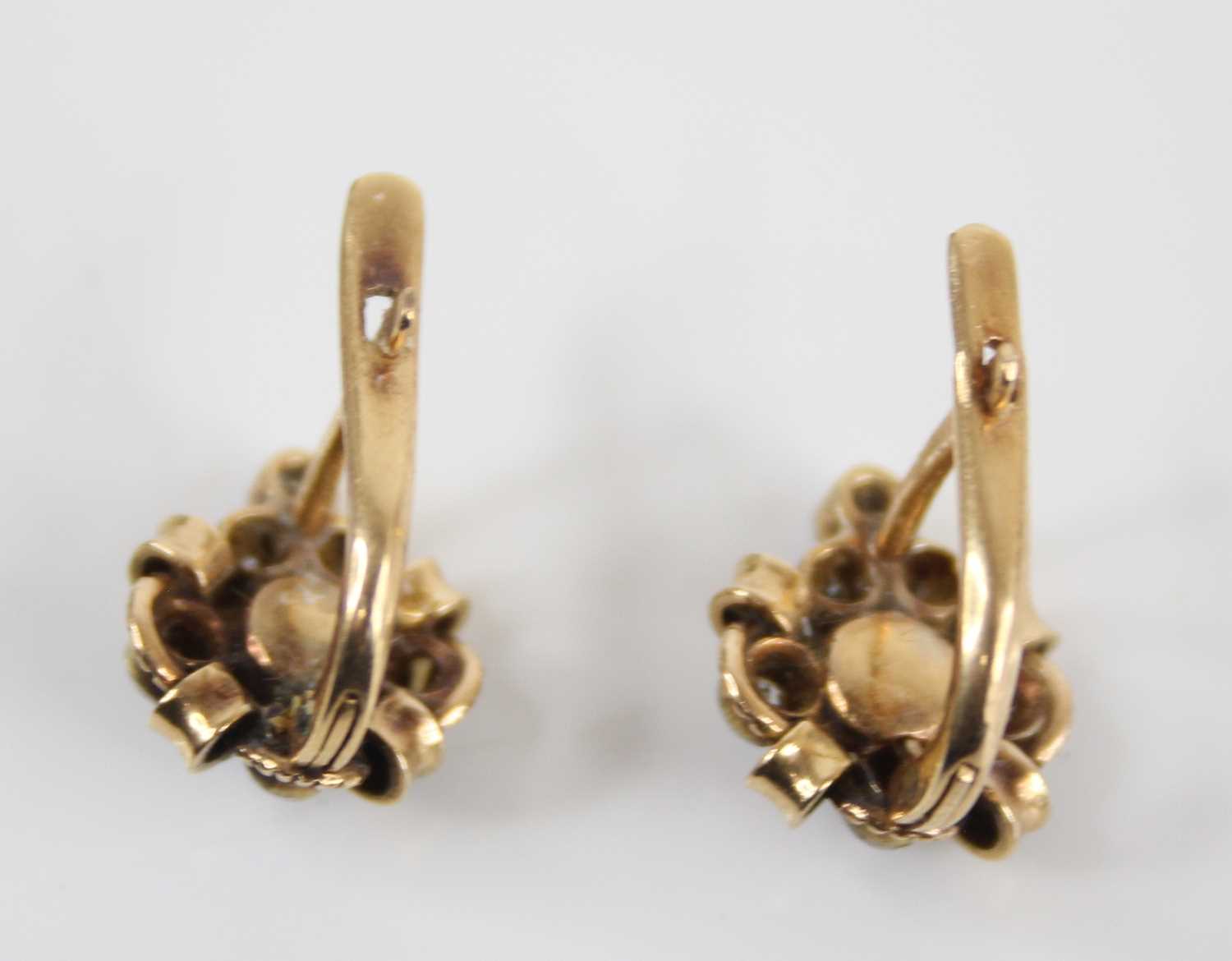 A pair of Victorian yellow metal, seed pearl and diamond set ear studs, on post fittings, arranged - Image 3 of 3